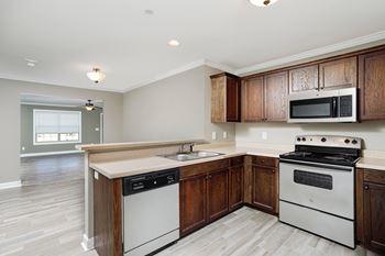 Kitchen with white appliances and wooden cabinets